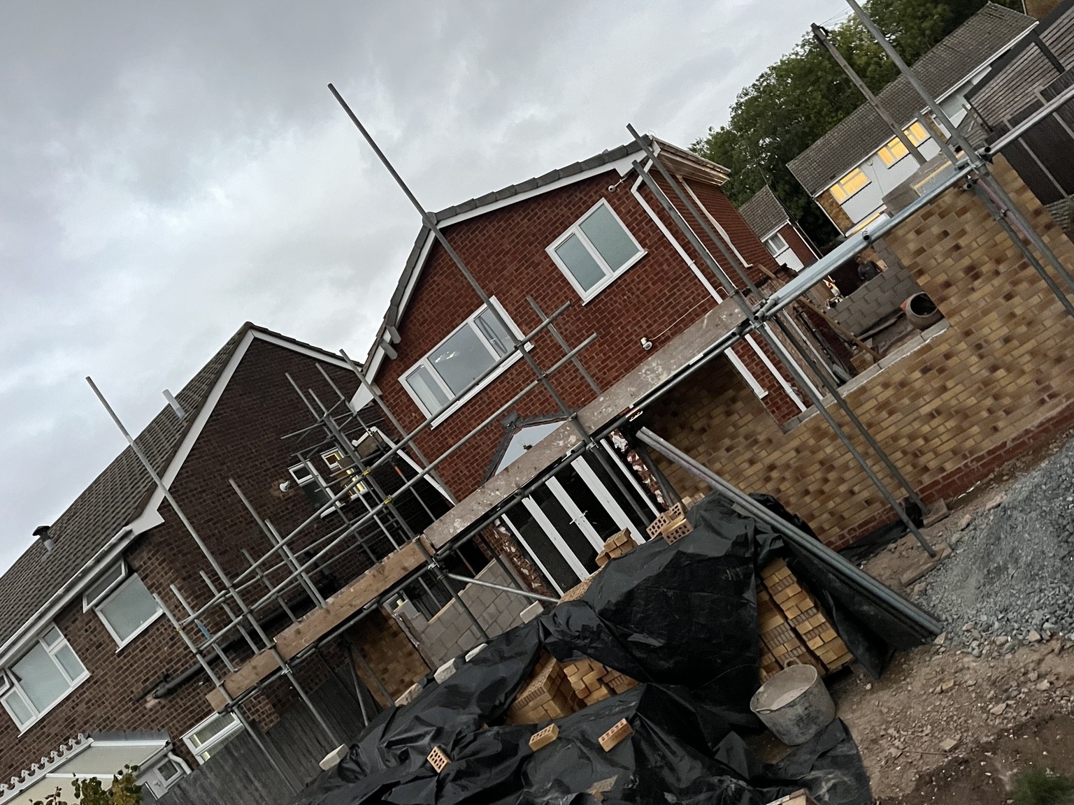 Scaffolding around a new-build house following demolition of the previous property in Solihull